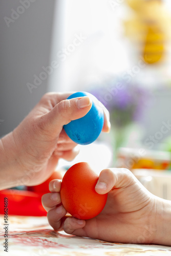 Mother and son play with decorative eggs on Easter day