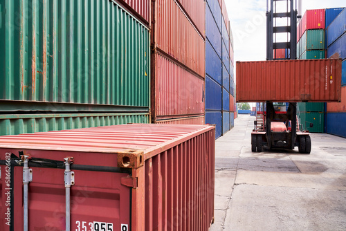 Container box stacking by folklift car in yard of logictic service site photo