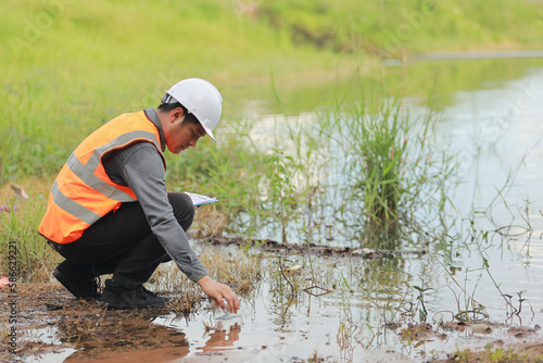 Environmental engineers work at water source to check for contaminants in water sources and analysing water test results for reuse.World environment day concept.