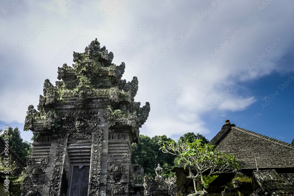 Balinese traditional gate during the day with blue sky background. Balinese traditional gate during the day with blue sky background.