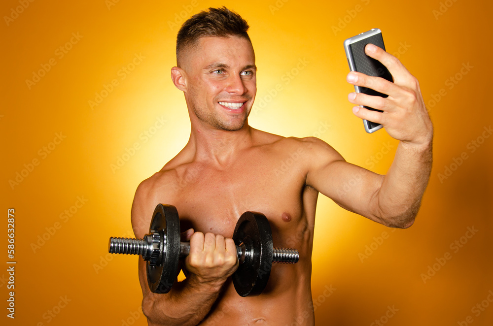 Young attractive man with athletic body posing in the studio. Orange background. Sports and healthy lifestyle. Young attractive man with athletic body posing in the studio. Orange background. Sports and healthy lifestyle.