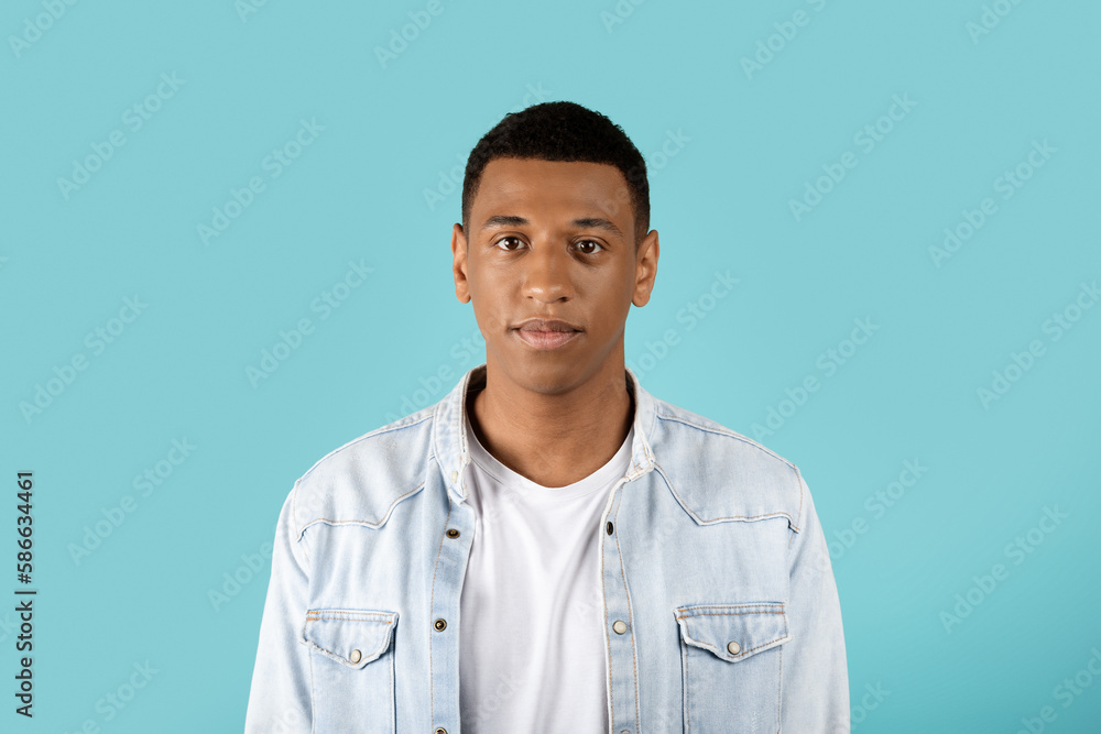 Portrait of serious calm sad millennial black guy in casual looking at camera Portrait of serious calm sad millennial black guy in casual looking at camera
