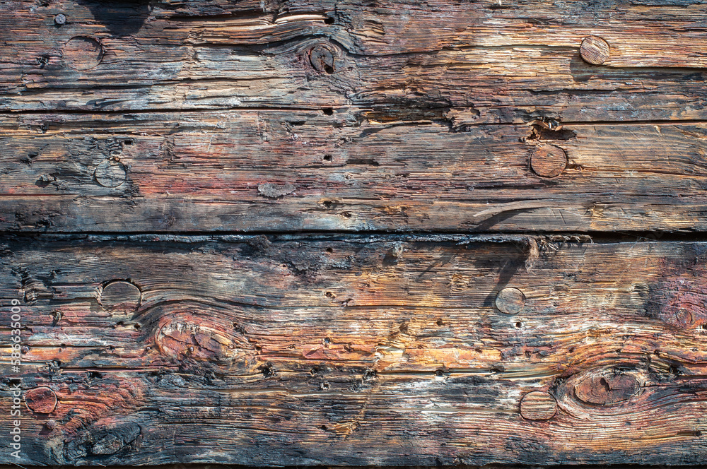 Naklejka premium Wooden planks from hull of an old ship. Closeup of wood planks. Texture background. Cover photo.
