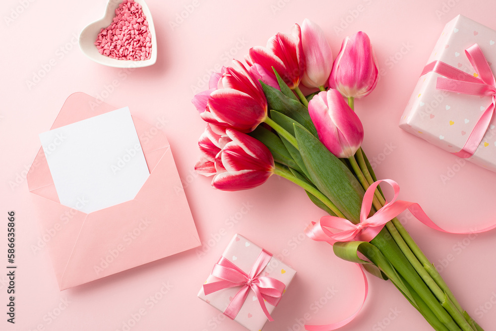 Mother's Day concept. Top view photo of bouquet of tulips tied with ribbon gift boxes open envelope with letter and heart shaped saucer with sprinkles on isolated pastel pink background with copyspace