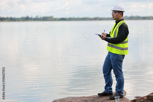 Environmental engineers work at water source to check for contaminants in water sources and analysing water test results for reuse.World environment day concept.