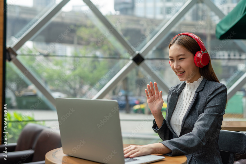 Young asian businesswoman working on her computer laptop and wearing a ...