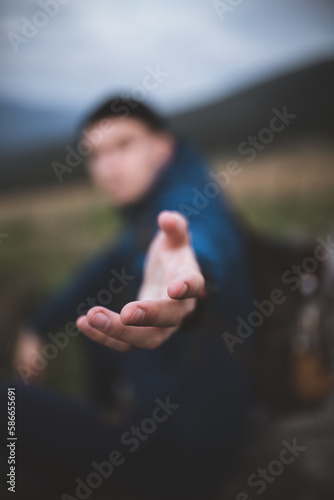 A clear hand, a person out of focus