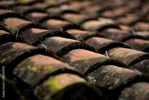 Aged clay roof. Clay tiles for exteriors. Natural clay. Selective focus.Pattern