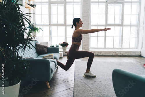 Slim woman practicing yoga at home