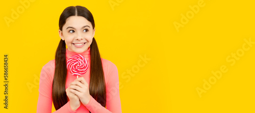 i am so glad. sweet tooth. yummy. happy girl hold lollipop. Teenager child with sweets, poster banner header, copy space. © Olena