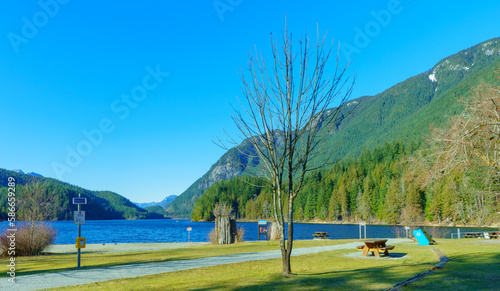 Lonely beach on a bright, sunny day at Buntzen Lake park, Anmore, BC, at the cusp of Spring.