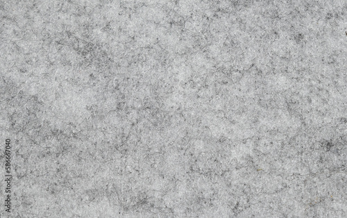 Natural gray felt background. Close-up surface structure, macro photography of the material