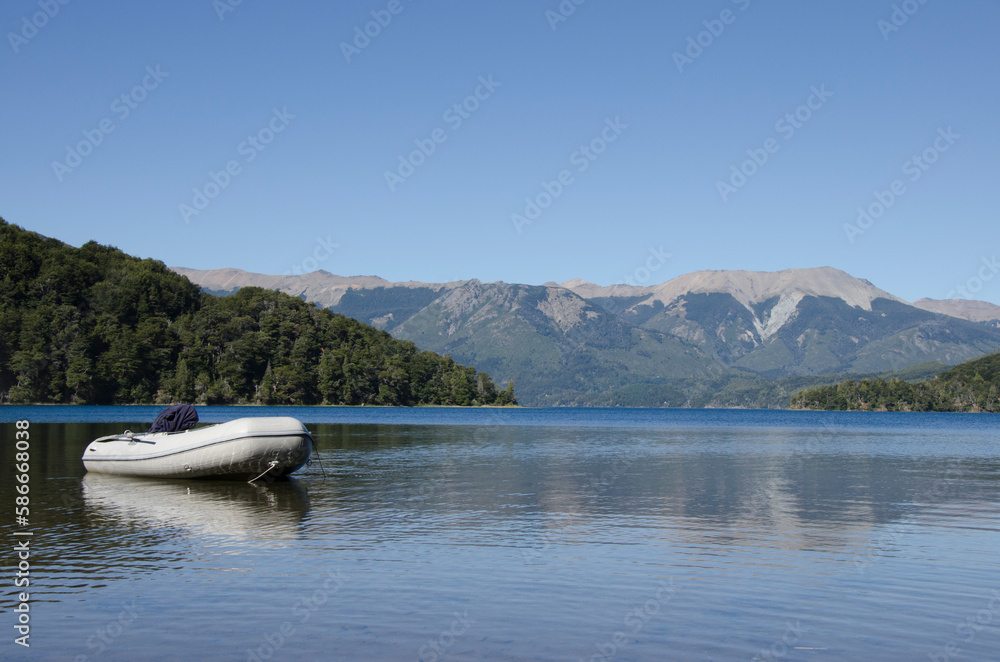 motorized rubber boat, parked on the shores of a lake in patagonia