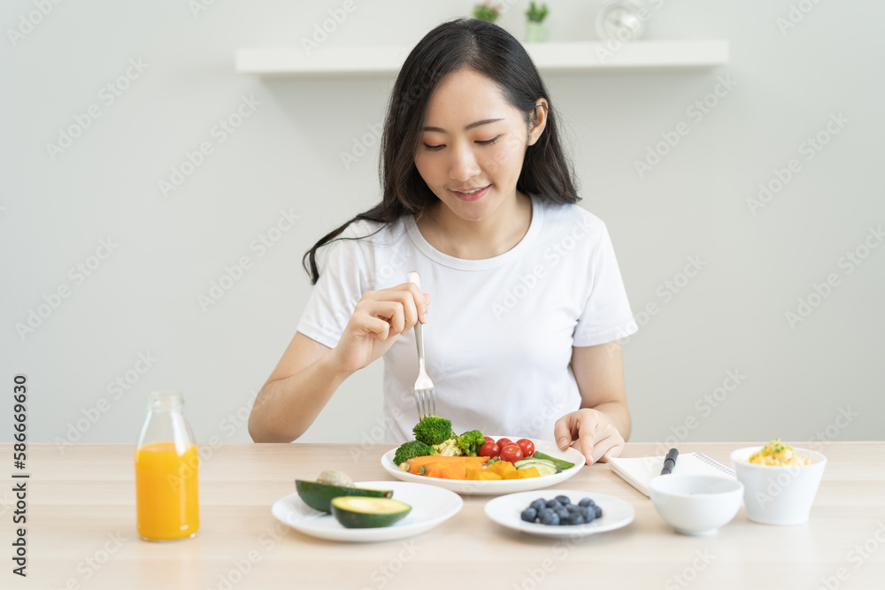 young female planning menu to eat ketogenic diet during weight loss program. young female planning menu to eat ketogenic diet during weight loss program.