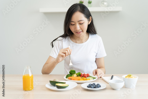 young female planning menu to eat ketogenic diet during weight loss program.