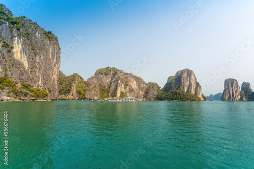 View of Ha Long Bay; with a lot of limestone islets and cruise ships; on summer day.