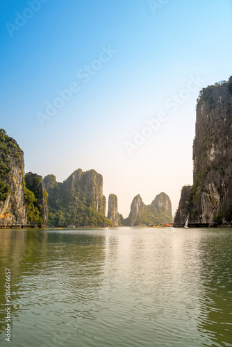 View of Ha Long Bay; with a lot of limestone islets and cruise ships; on summer day.