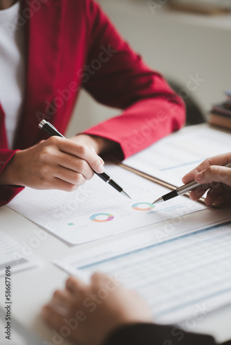 Two businessmen are brainstorming together and reviewing the company financial documents that the finance department has summarized, they are business partners. Business administration concept.