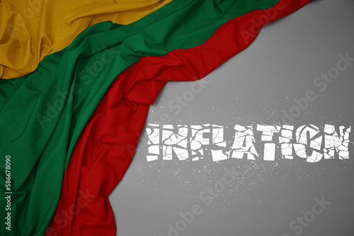 waving colorful national flag of lithuania on a gray background with broken text inflation. 3d illustration
