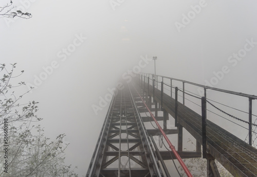 Fototapeta Naklejka Na Ścianę i Meble -  Beautiful view from Fansipan mountain with red train for tourist tram. Steel construction wood and glass European style in Sa Pa, Lao Cai Province, Vietnam