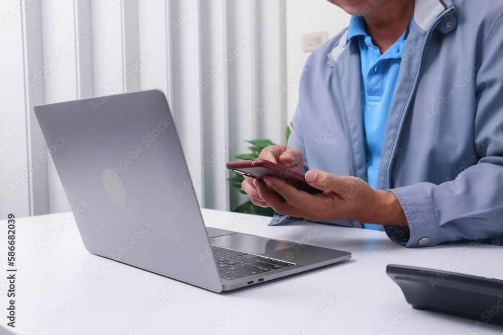 Businessman using a calculator in the office budget and loan paper in the office. Businessman using a calculator in the office budget and loan paper in the office.