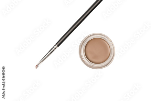 A brow pomade in blonde shade with brush isolated on a white background.