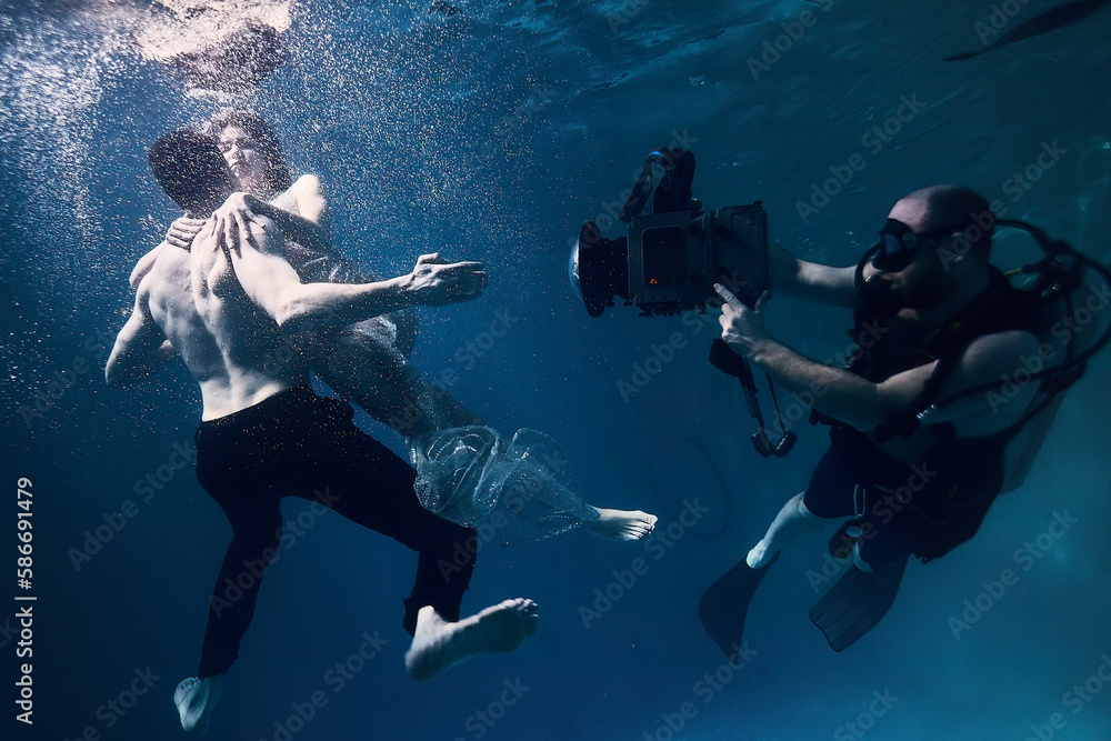 filming a movie underwater underwater cameraman and actors Stock Photo