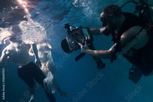filming a movie underwater underwater cameraman and actors