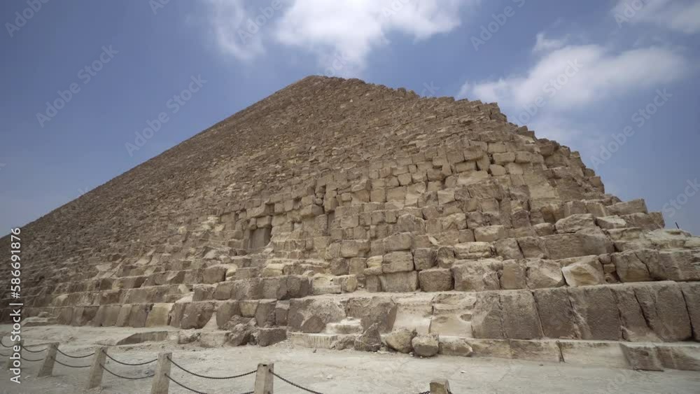 The Great Pyramid of Giza against blue sky. Cairo, Egypt. Traveling, world wonder and historic concept. The Great Pyramid of Giza against blue sky. Cairo, Egypt. Traveling, world wonder and historic concept.