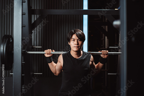 Man working out Bodybuilder with barbell weights at the gym. bodybuilder doing exercises with barbell. training sport healthy lifestyle bodybuilding, Athlete builder muscles lifestyle.