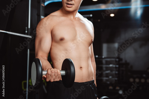 Male working out Bodybuilder with dumbbell weights at the gym.man bodybuilder doing exercises with dumbbell. training sport healthy lifestyle bodybuilding, Athlete builder muscles lifestyle...