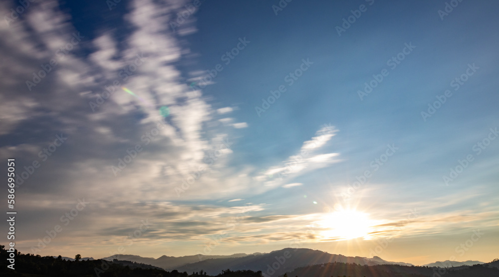 sun rising above the mountains, horizontal scenery 
