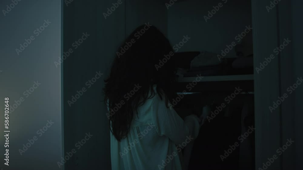 girl chooses clothes from wardrobe early in the morning girl chooses clothes from wardrobe early in the morning