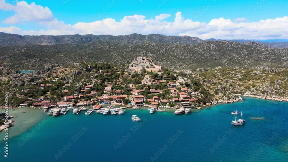 Drone video featuring Simena Castle (Kaleköy), beach, and yachts, providing a captivating view of the historical landmark and Mediterranean landscape in Antalya, Turkey. Drone video featuring Simena Castle (Kaleköy), beach, and yachts, providing a captivating view of the historical landmark and Mediterranean landscape in Antalya, Turkey.