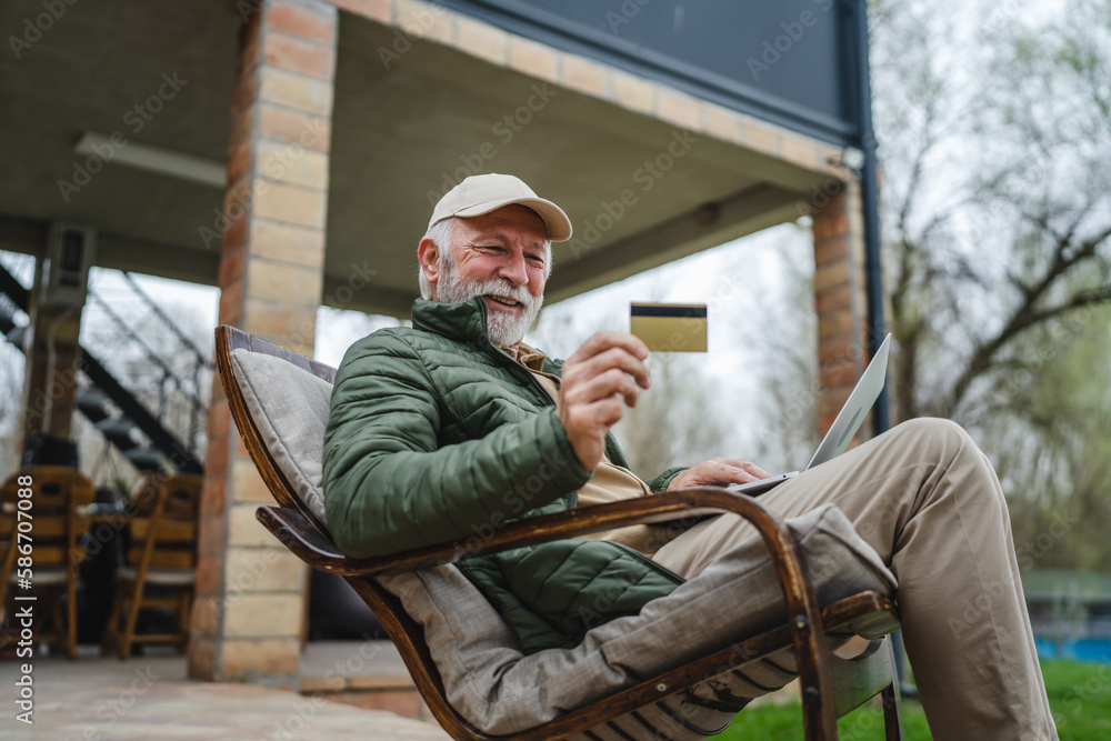 Man senior caucasian male shopping online sit with laptop computer Man senior caucasian male shopping online sit with laptop computer