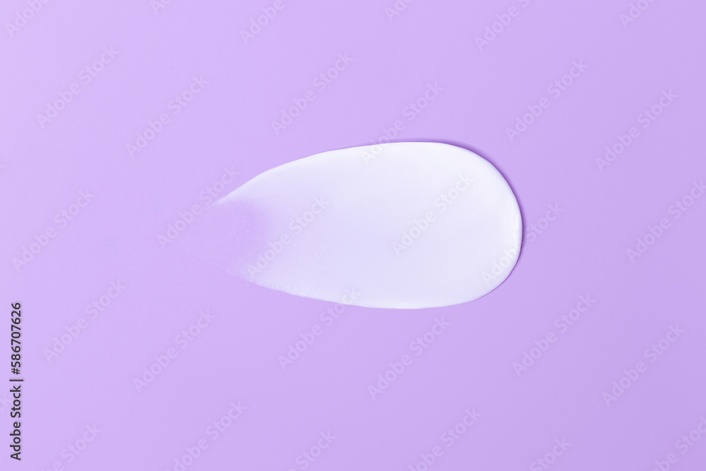 Close-up smear of cream texture on a purple background Close-up smear of cream texture on a purple background