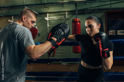 Practicing punching in the ring with trainer © cherryandbees