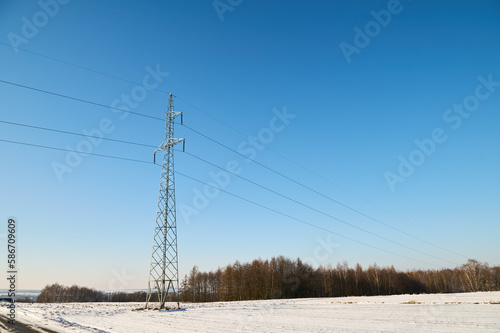 Wires and power pole against a cloudless blue sky