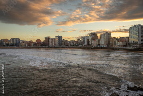 Exposure from the Gijon boardwalk of the beautiful seafront with great waves for surfing at Sunset, Spain. © Paulo