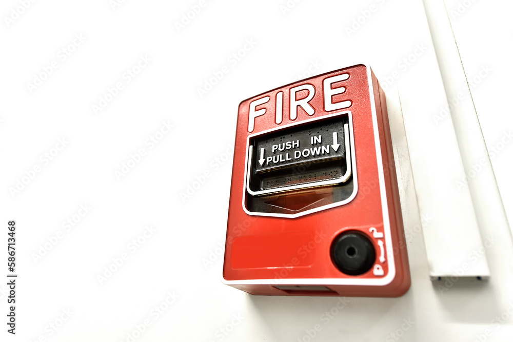 Fototapeta premium Red fire alarm button in the building. Push in pull down.