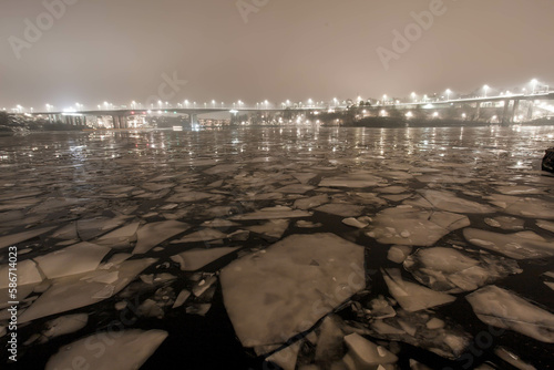 Photography City lights over ice floes and water