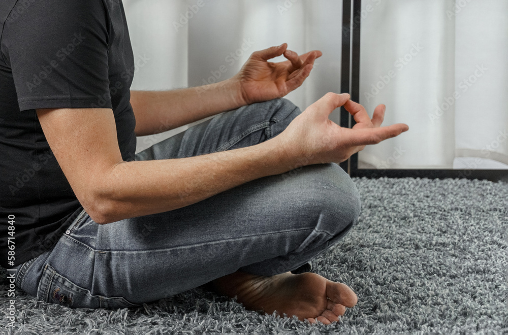 A man meditates in the lotus position.