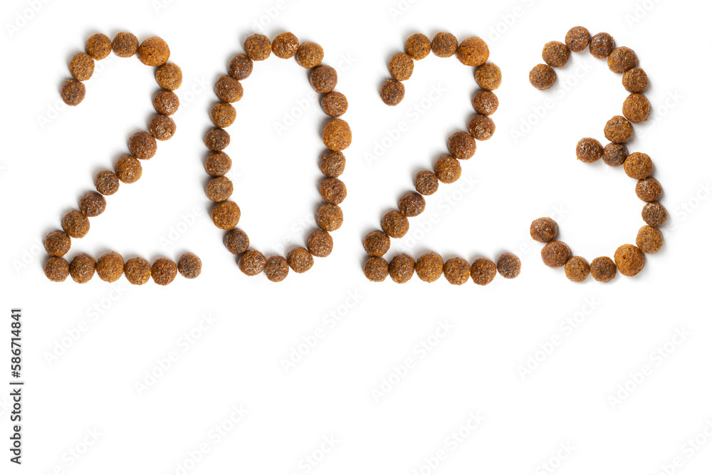 Calendar 2023 from Dry pet food on a white background. Granules of good nutrition for dogs and cats Calendar 2023 from Dry pet food on a white background. Granules of good nutrition for dogs and cats