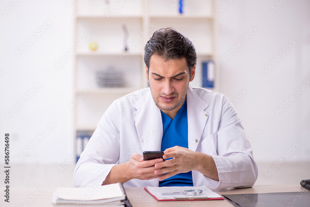 Young male doctor in telemedicine concept Young male doctor in telemedicine concept