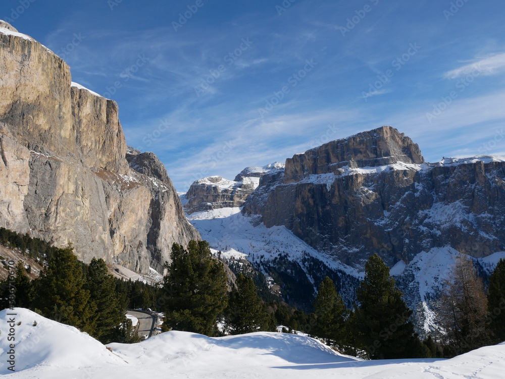 Sella Pass, Selva Val Gardena, Bozen, Italy: panoramic view of snow covered Sass Pordoi, Dolomites, from Sella Pass, in a sunny winter day