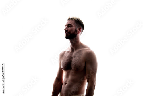 Portrait of a shirtless muscular young man on a white background.