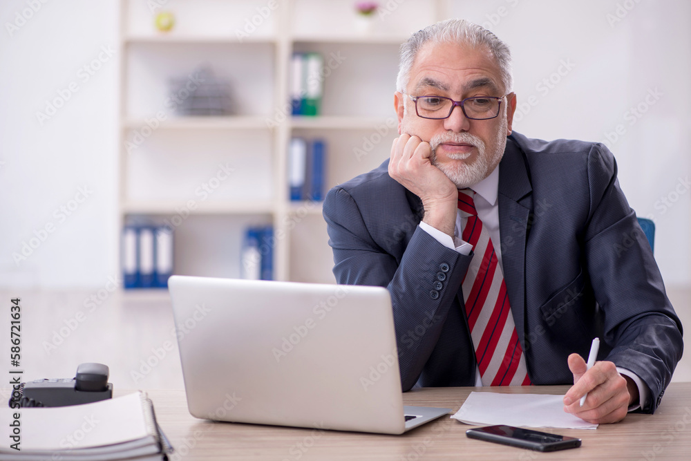 Old male employee and too much work in the office Old male employee and too much work in the office