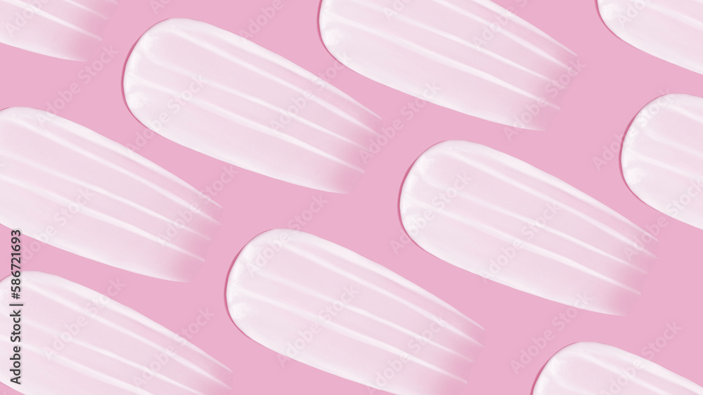 The background is cosmetic. Many smears of cream on a pink pink background The background is cosmetic. Many smears of cream on a pink pink background