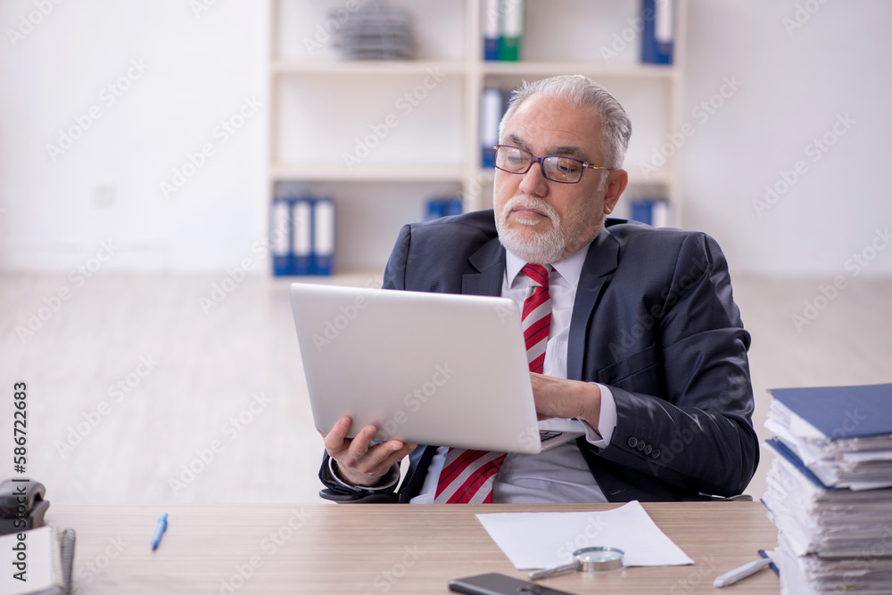 Old male employee and too much work in the office Old male employee and too much work in the office