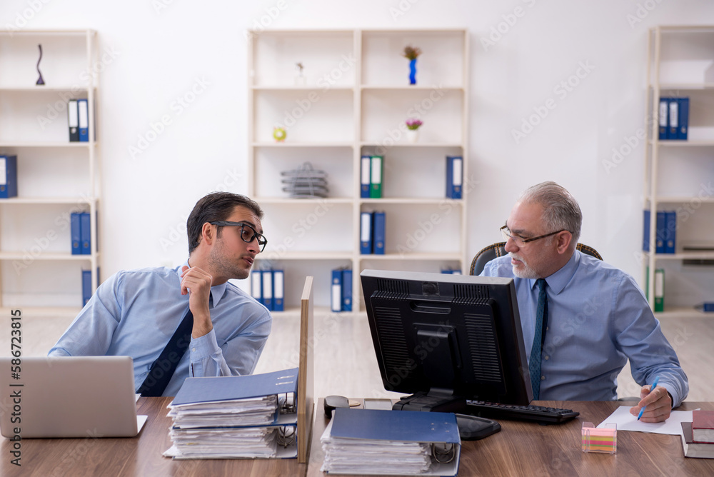 Two male colleagues working in the office Two male colleagues working in the office